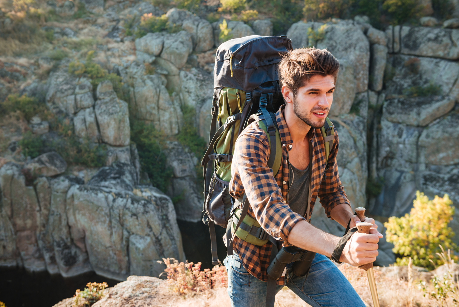 Male Traveler with Backpack in Mountain